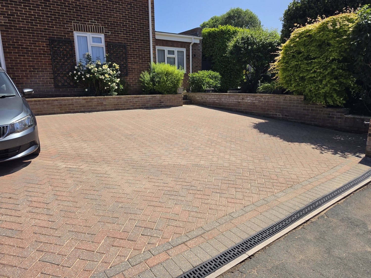 The same driveway after new block paving, brick edging and a drainage channel by Green Leaf Landscape Services