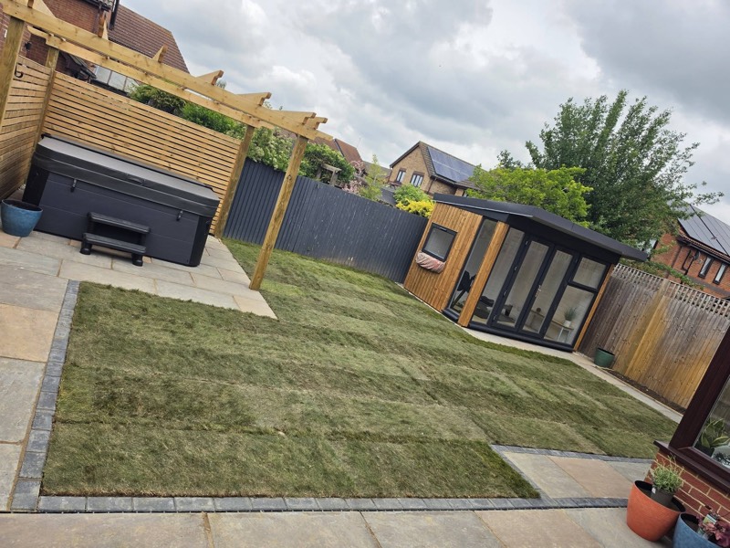 New sandstone patio and lawn in a completed garden makeover by Green Leaf Landscape Services