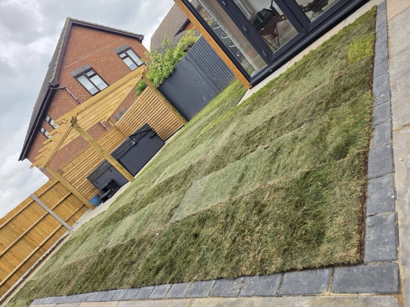 Fresh turf laid up to a paved edge by Green Leaf Landscape Services